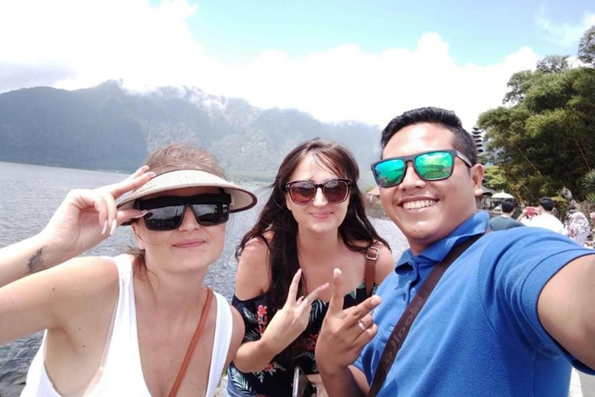 a group of people standing on a boat in the water