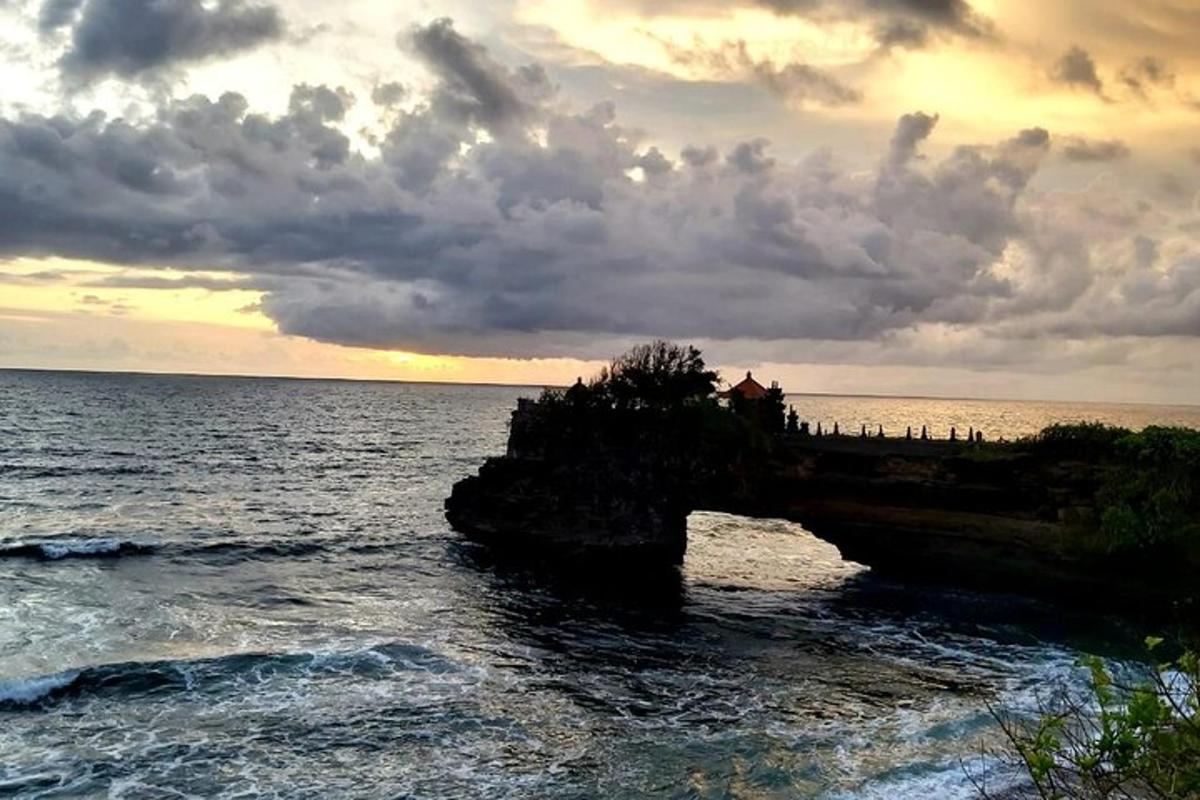 a group of people standing on a bridge over the ocean