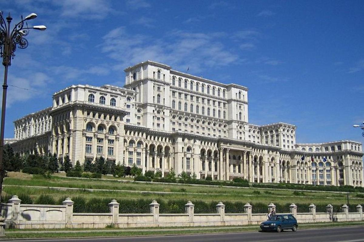 a large white building with a car in front of it