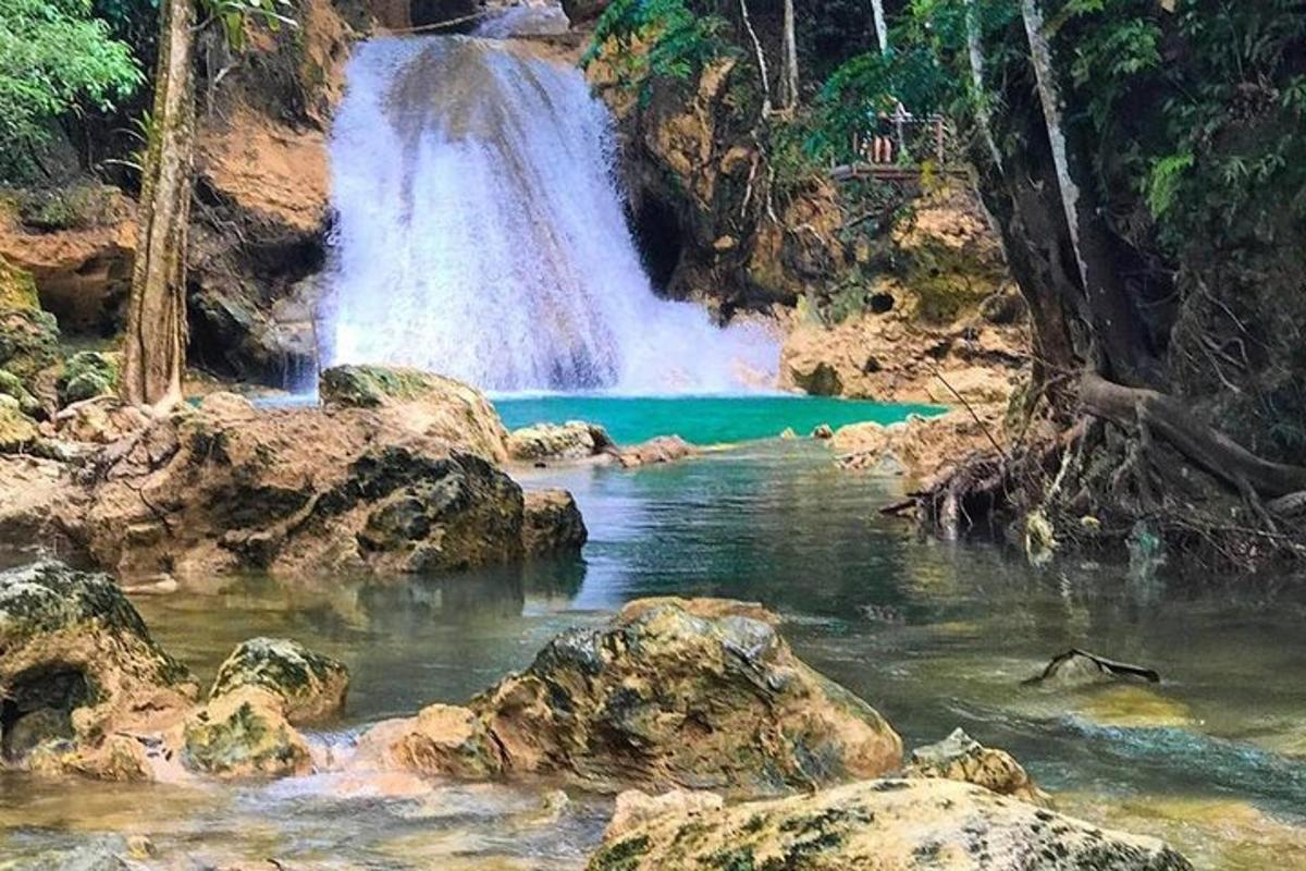 a waterfall in front of a pool of water