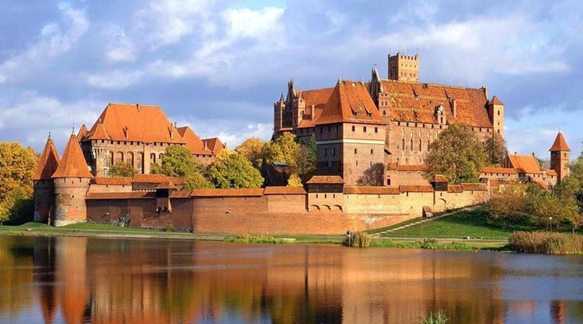 a large castle sitting next to a body of water