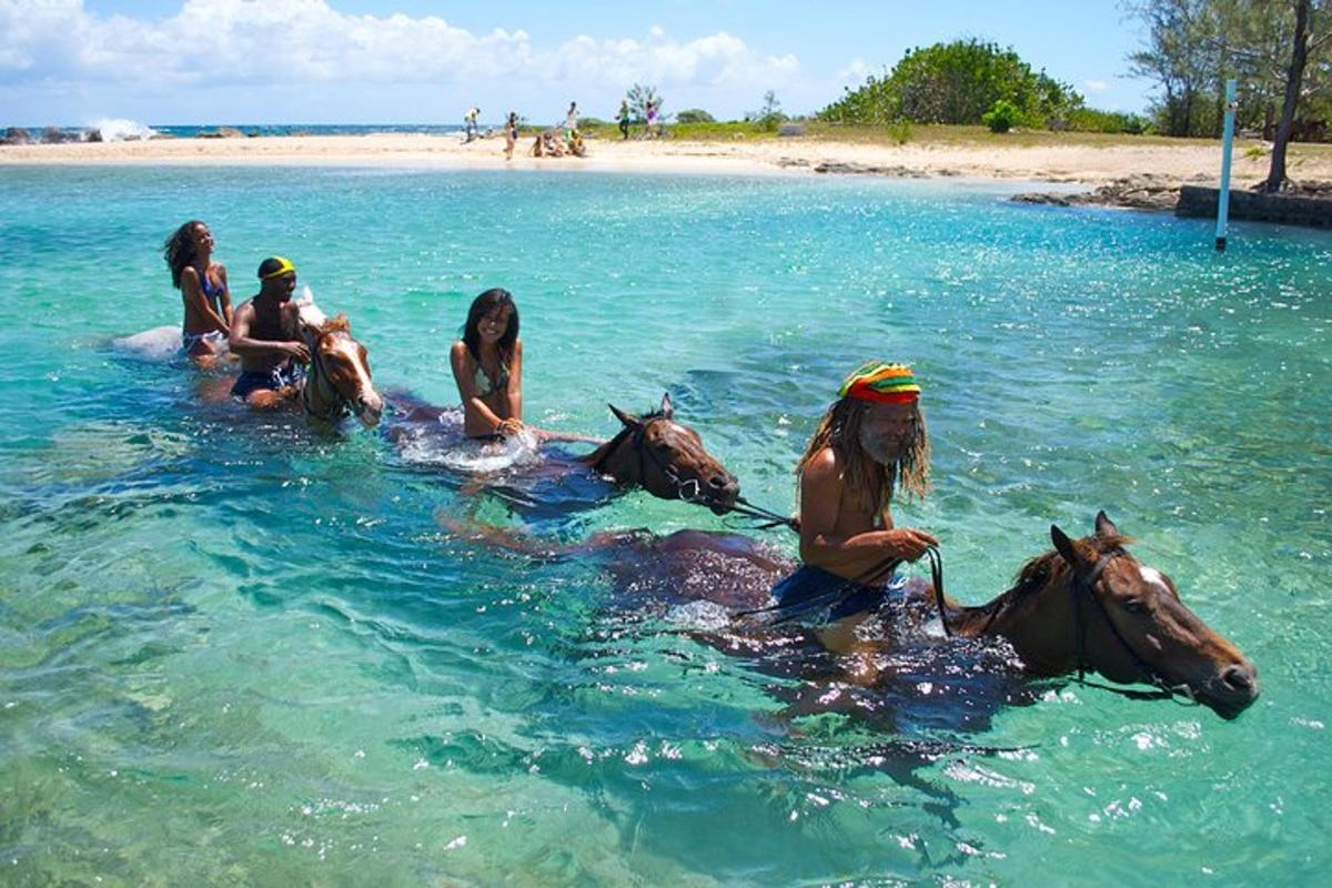 a group of girls riding horses in the water
