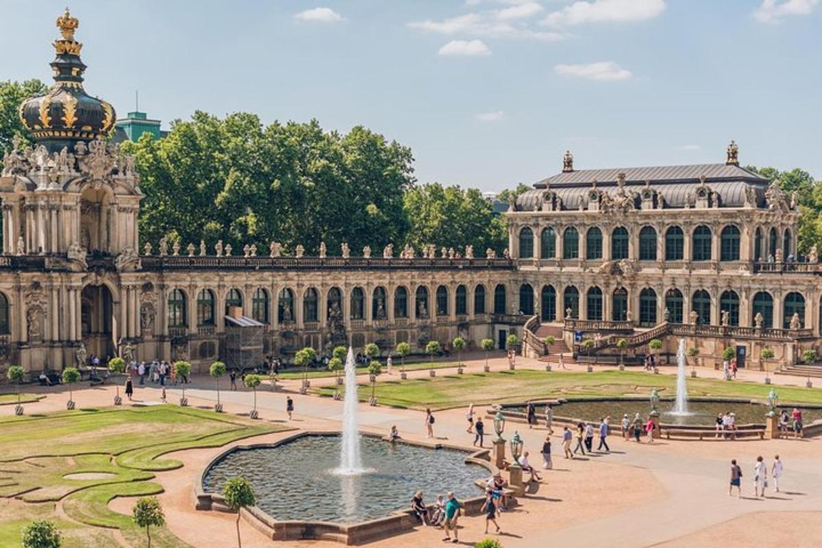 a large building with a fountain in the middle of a courtyard