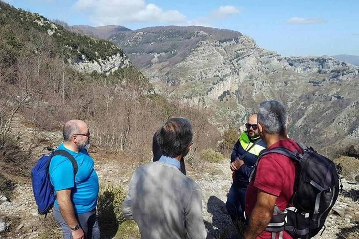 a group of men standing on top of a mountain