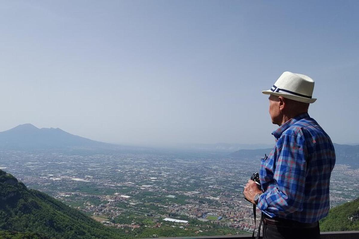 a man standing on top of a mountain with a camera
