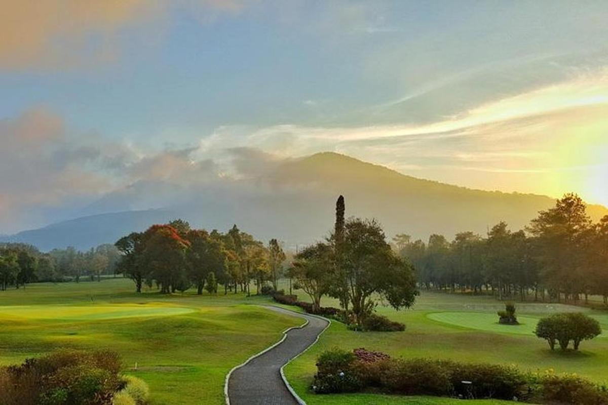 a winding road leading to a golf course