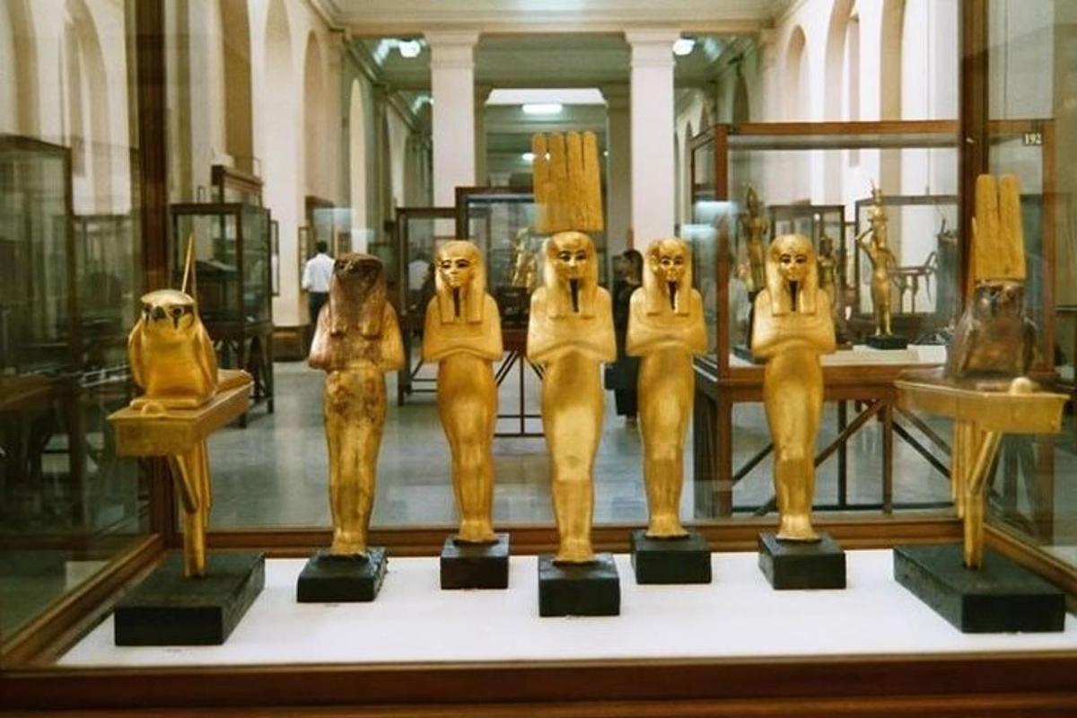 a group of statuettes in a display case in a museum