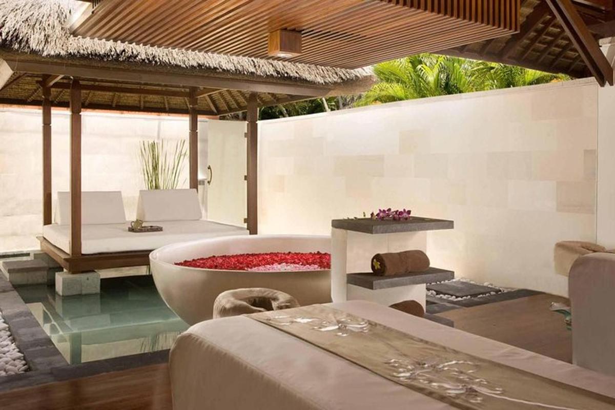 a room with a bathtub and a bed and a bedroom