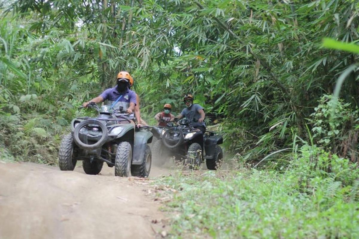 un gruppo di persone che guidano quad su una strada sterrata