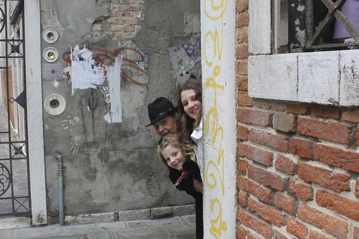 a man and a woman standing next to a brick wall