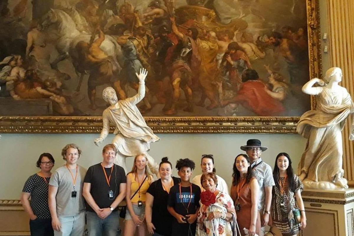 a group of people standing in front of a painting