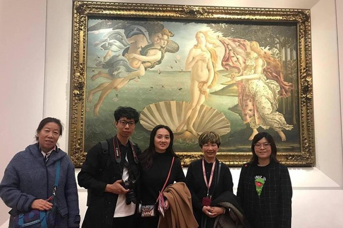 a group of people standing in front of a painting