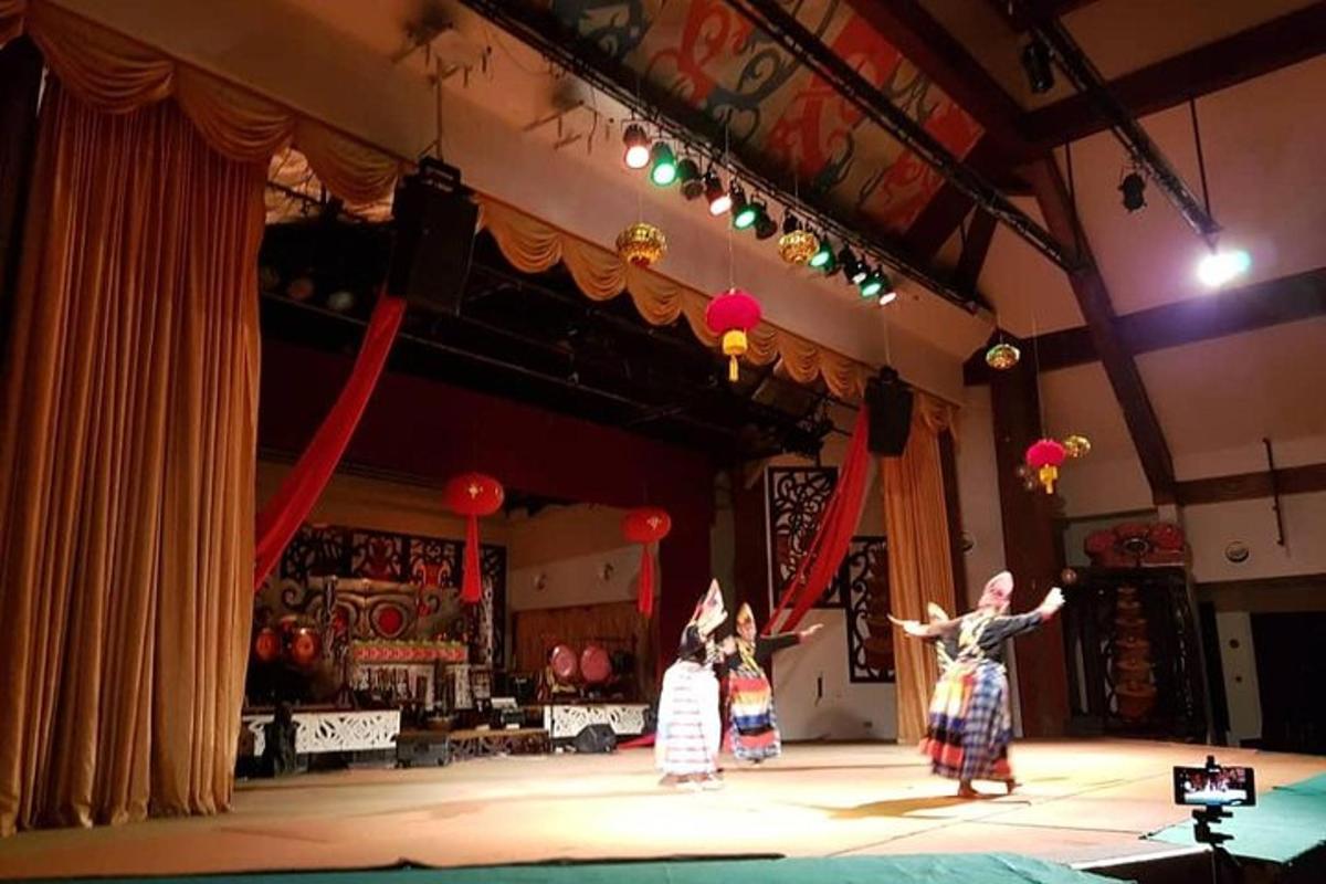 two people are dancing on a stage in a theatre