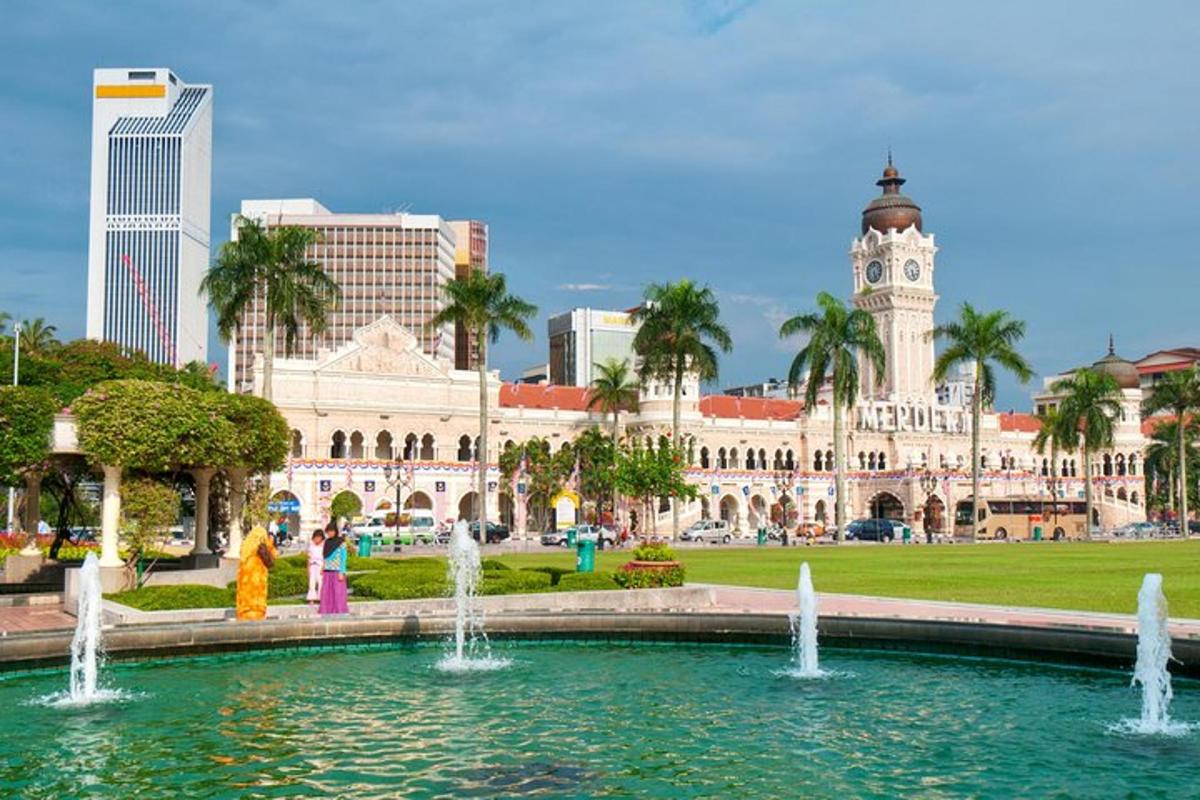 a fountain in front of a building with a clock tower