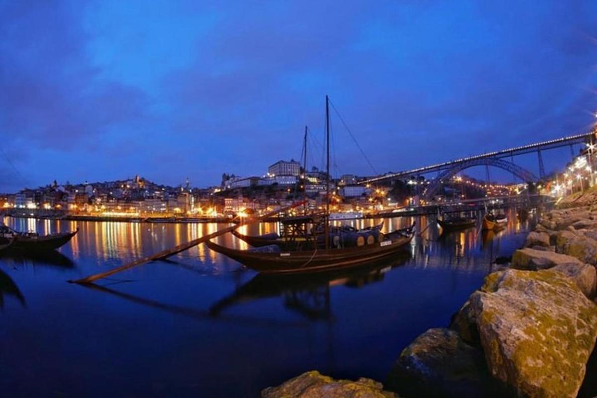 a boat in the water near a bridge at night