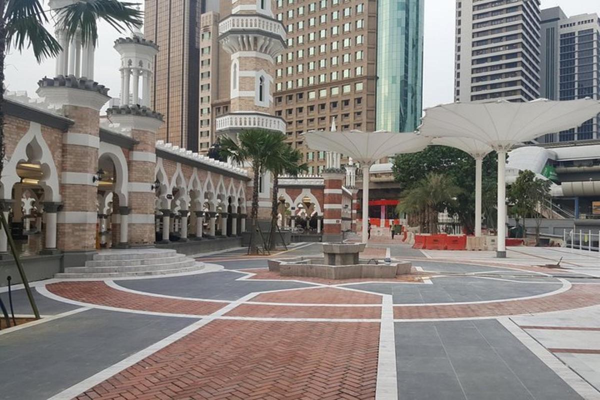 a courtyard with umbrellas in the middle of a city