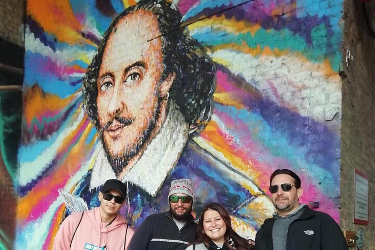 a group of people standing in front of a mural