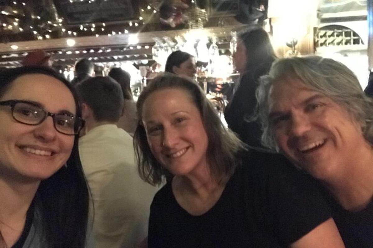 a group of three people posing for a picture