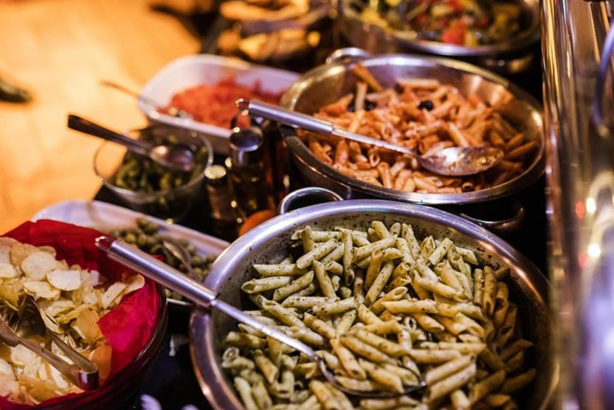 a buffet of different types of food in metal pans