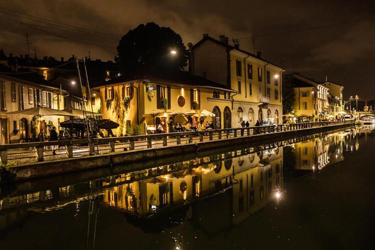 a city at night with a reflection in the water