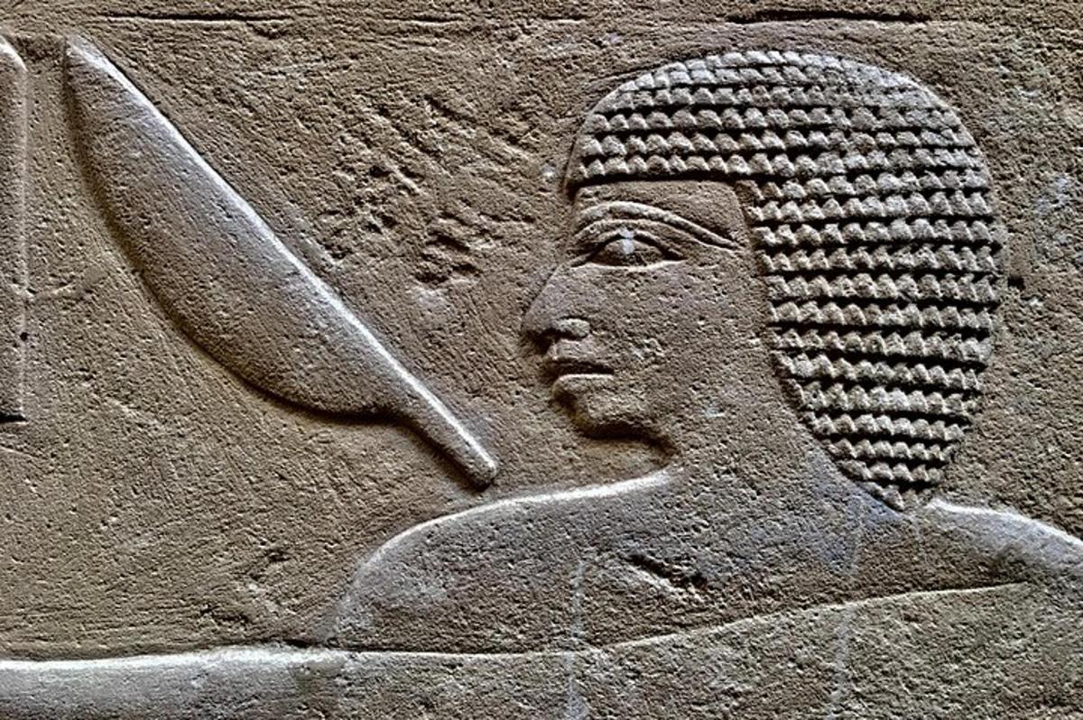 a stone statue of a sphinx on a wall