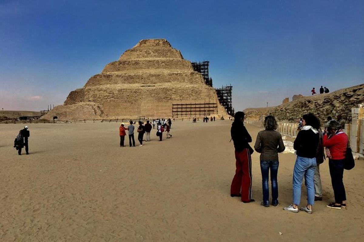 a group of people standing in front of a pyramid