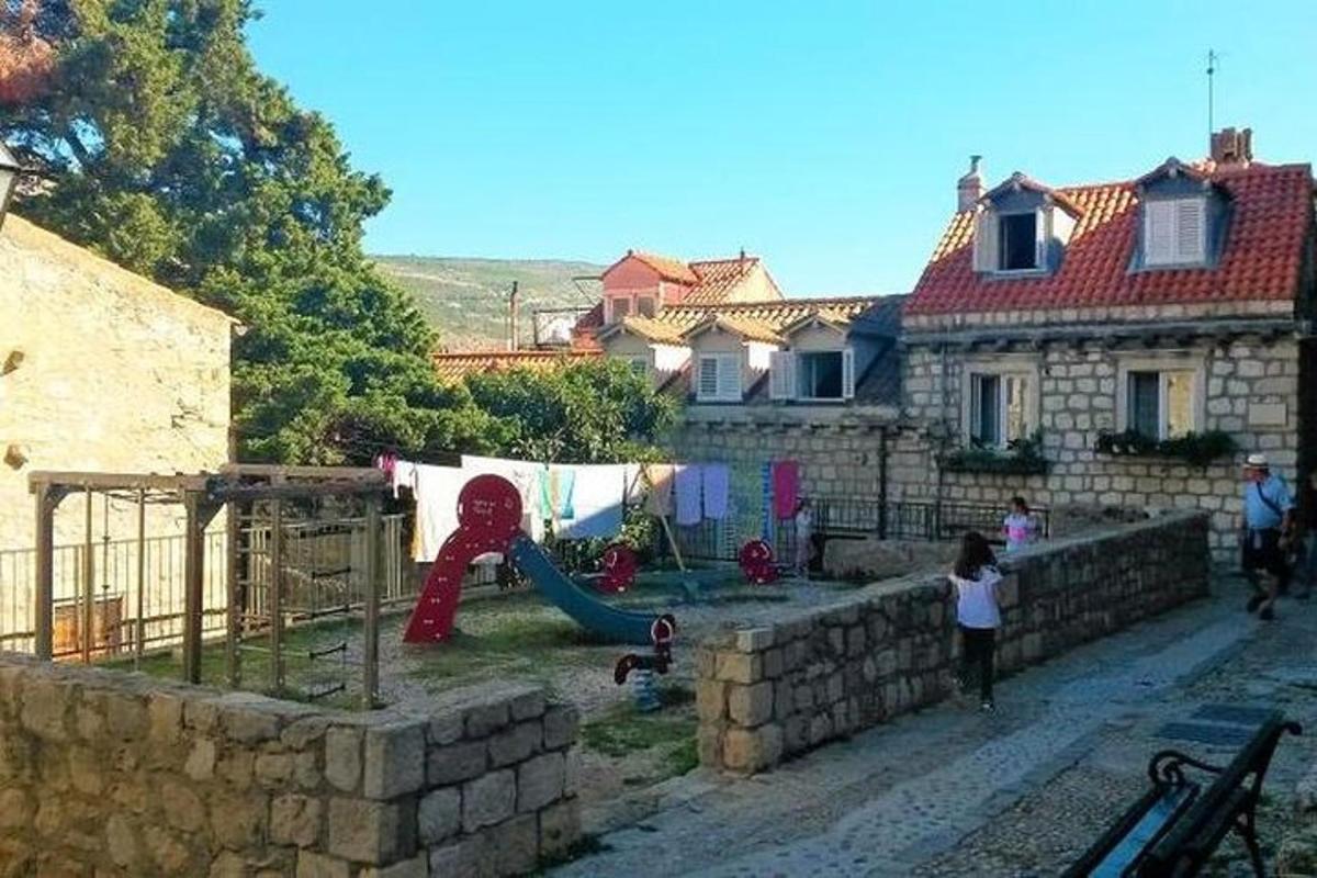 ένα παιδί που παίζει σε μια παιδική χαρά μπροστά από ένα σπίτι