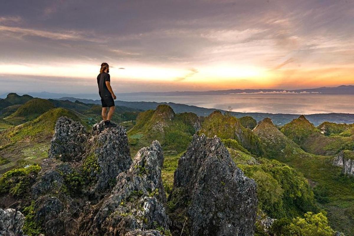 a man standing on the top of a mountain