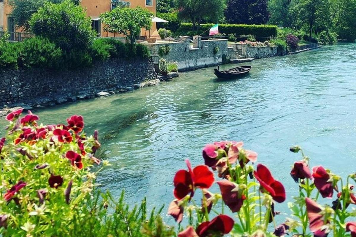Un barco en un río con flores en primer plano.