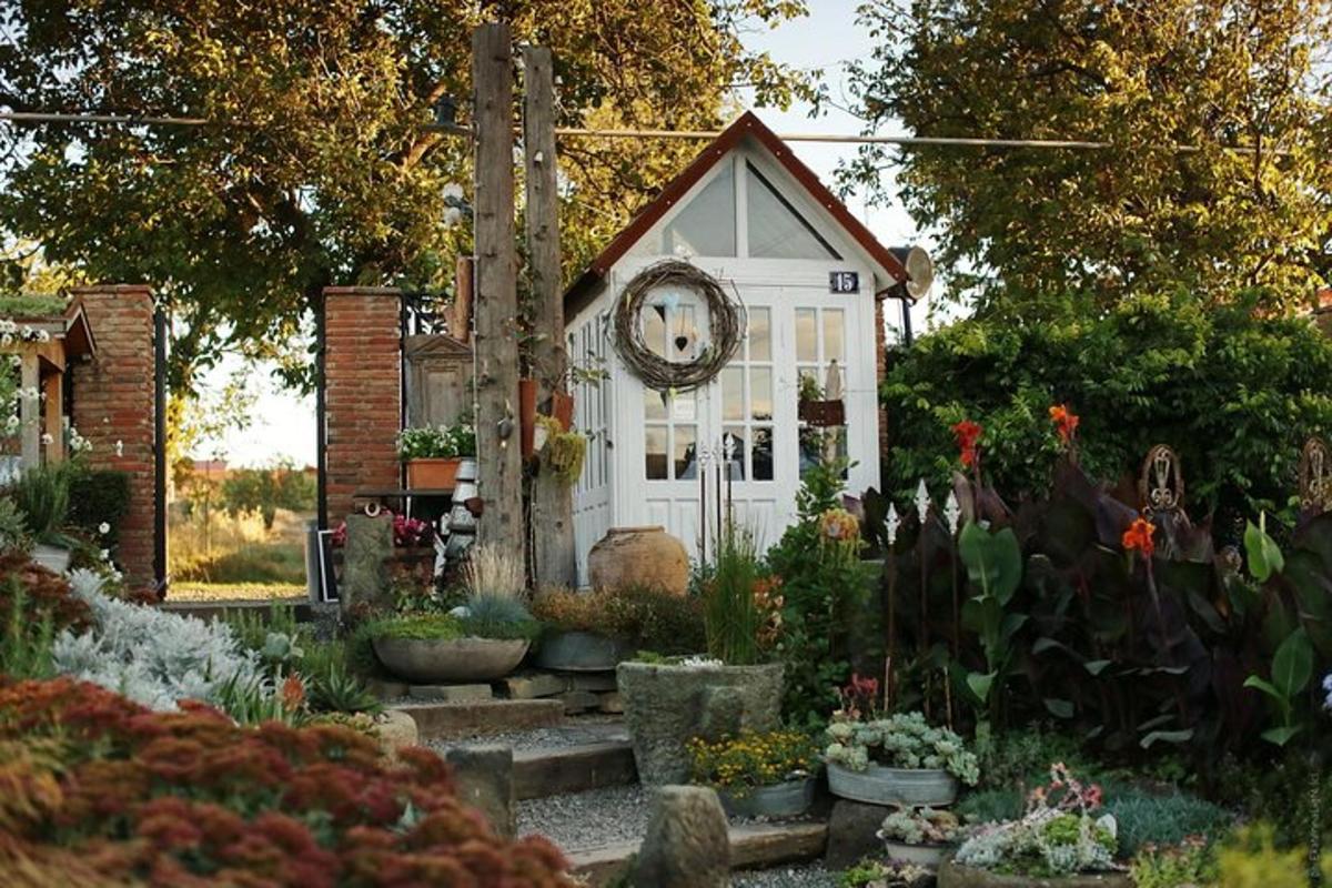 a small white house with a clock on it