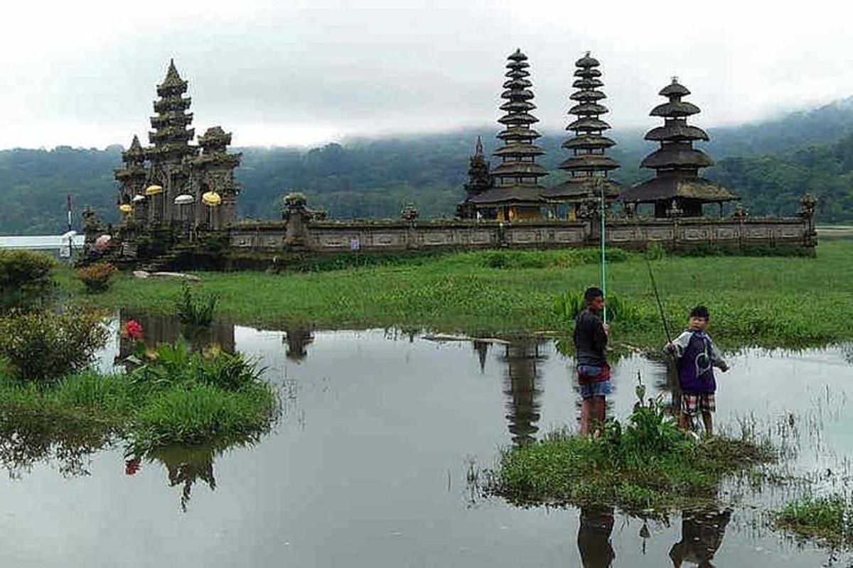 two children are standing in a body of water