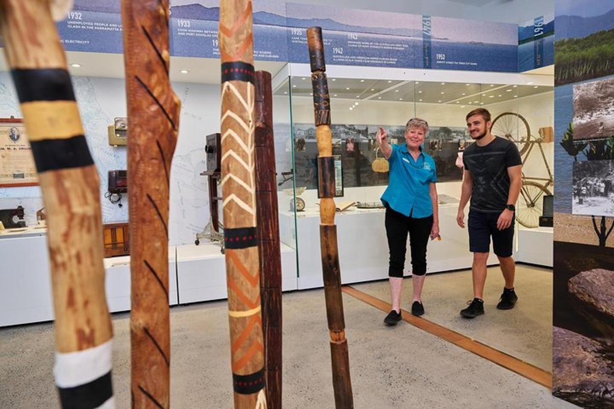 a man and a woman standing next to two ski poles