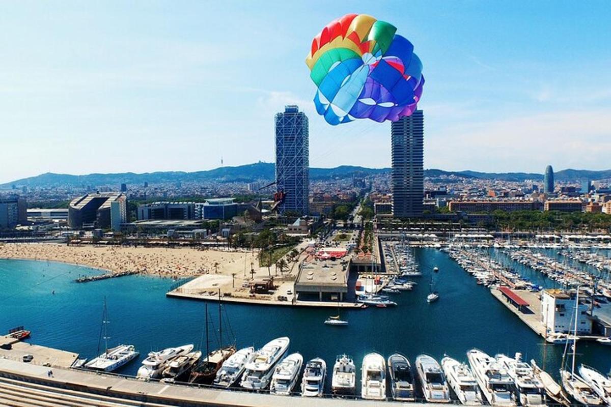 a large colorful balloon flying over a harbor with boats