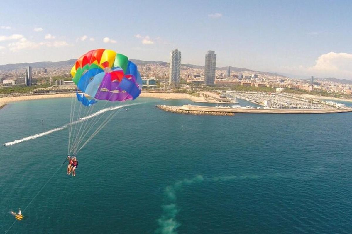a person riding a parachute over the water