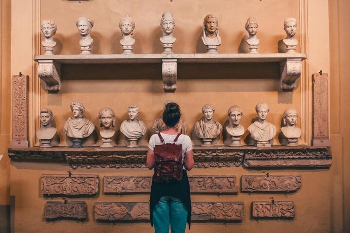 a woman standing in front of a display of statues