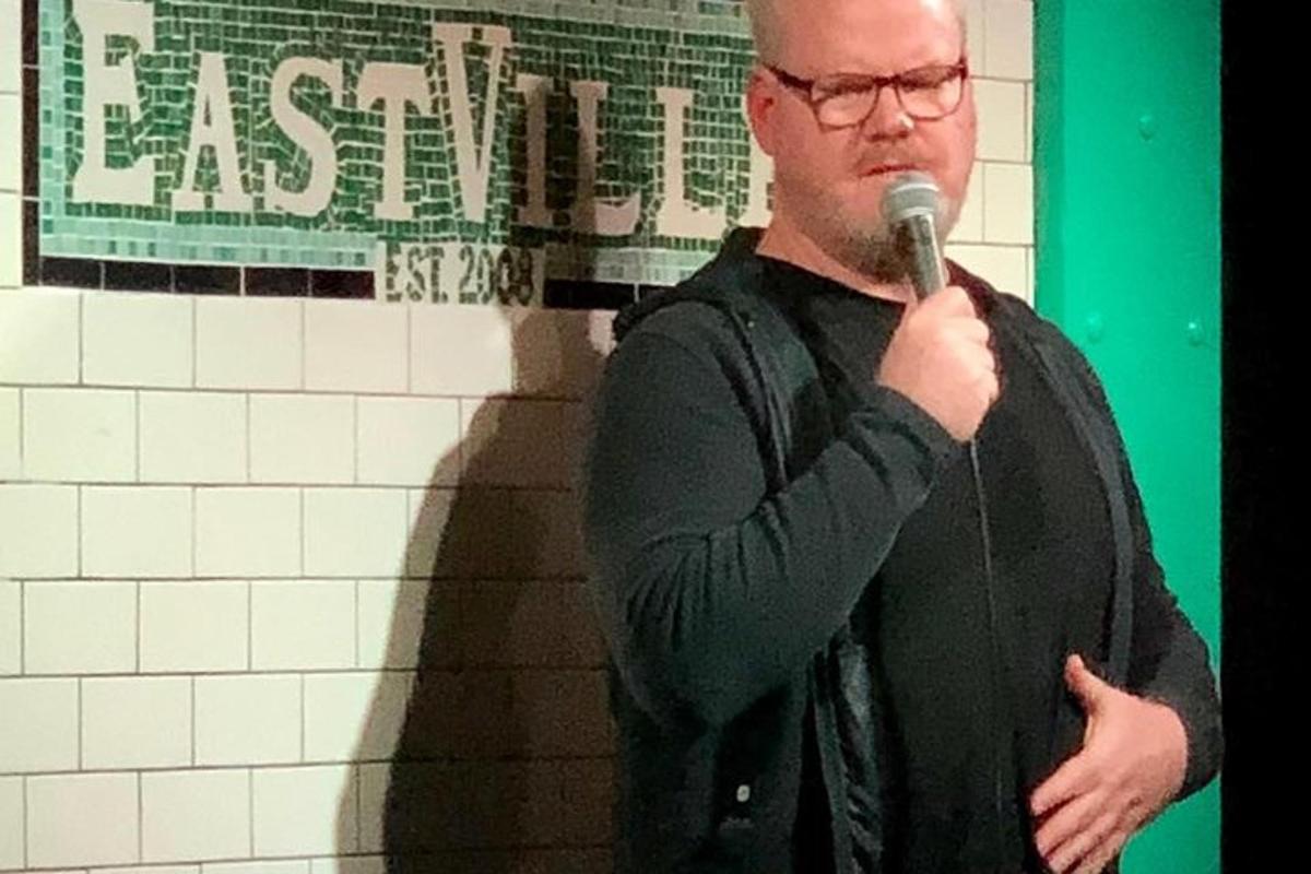 a man standing with a microphone in his hand