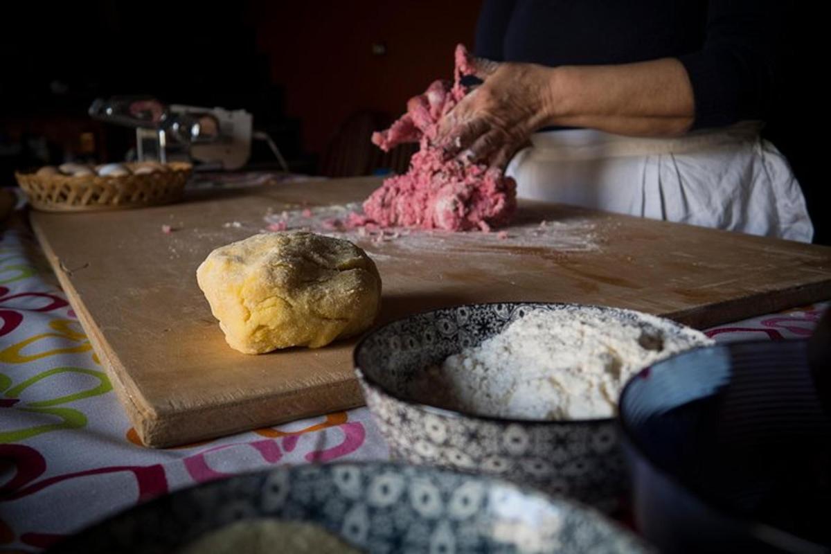 a person preparing meat on a wooden cutting board