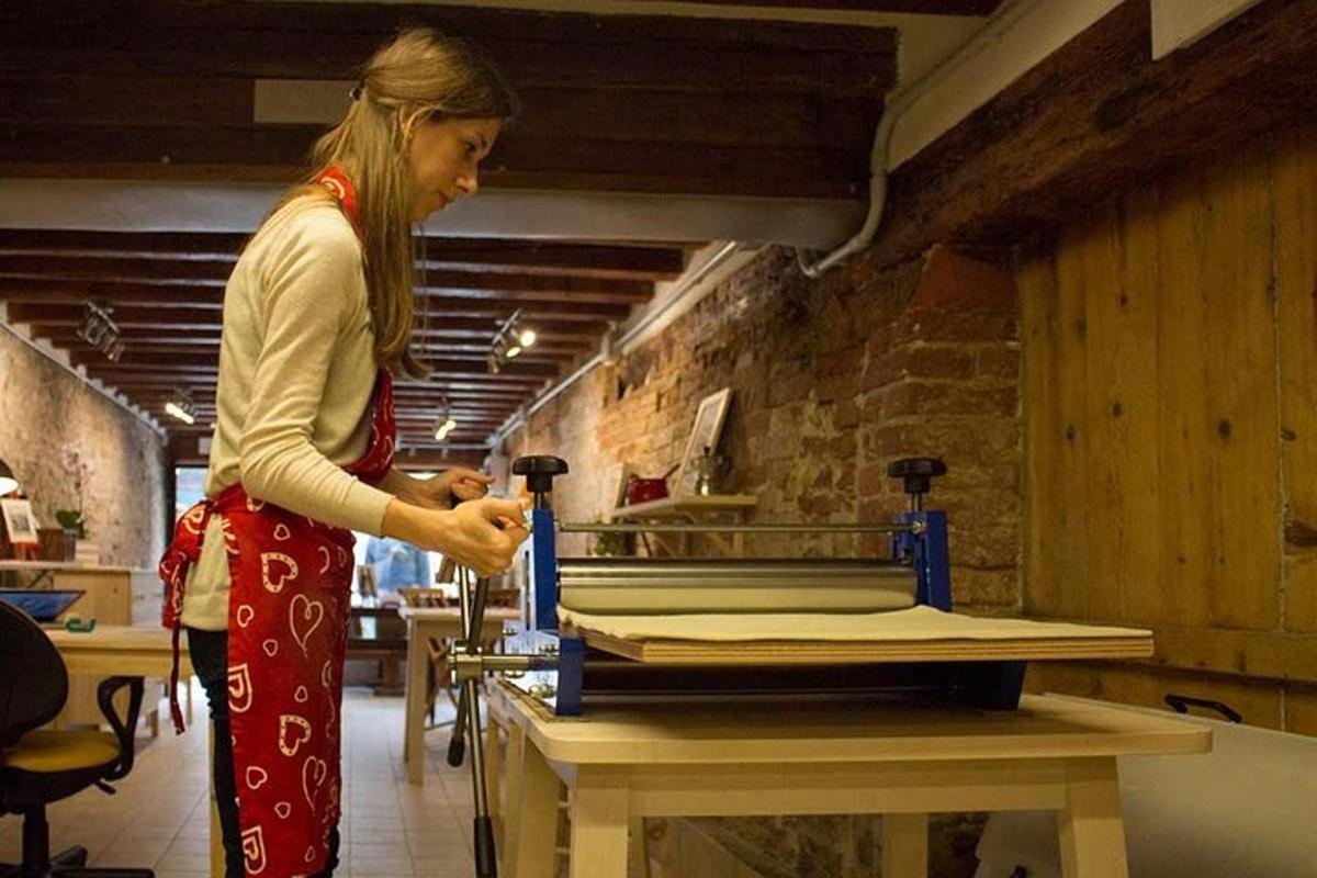 a woman standing in front of a table in a kitchen