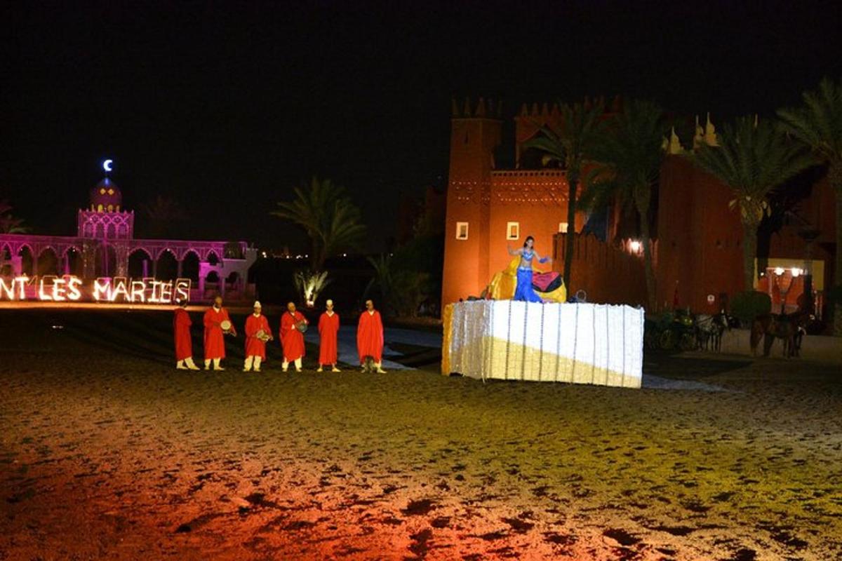 a group of people standing on a stage at night