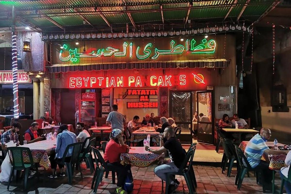 a group of people sitting at tables in a restaurant