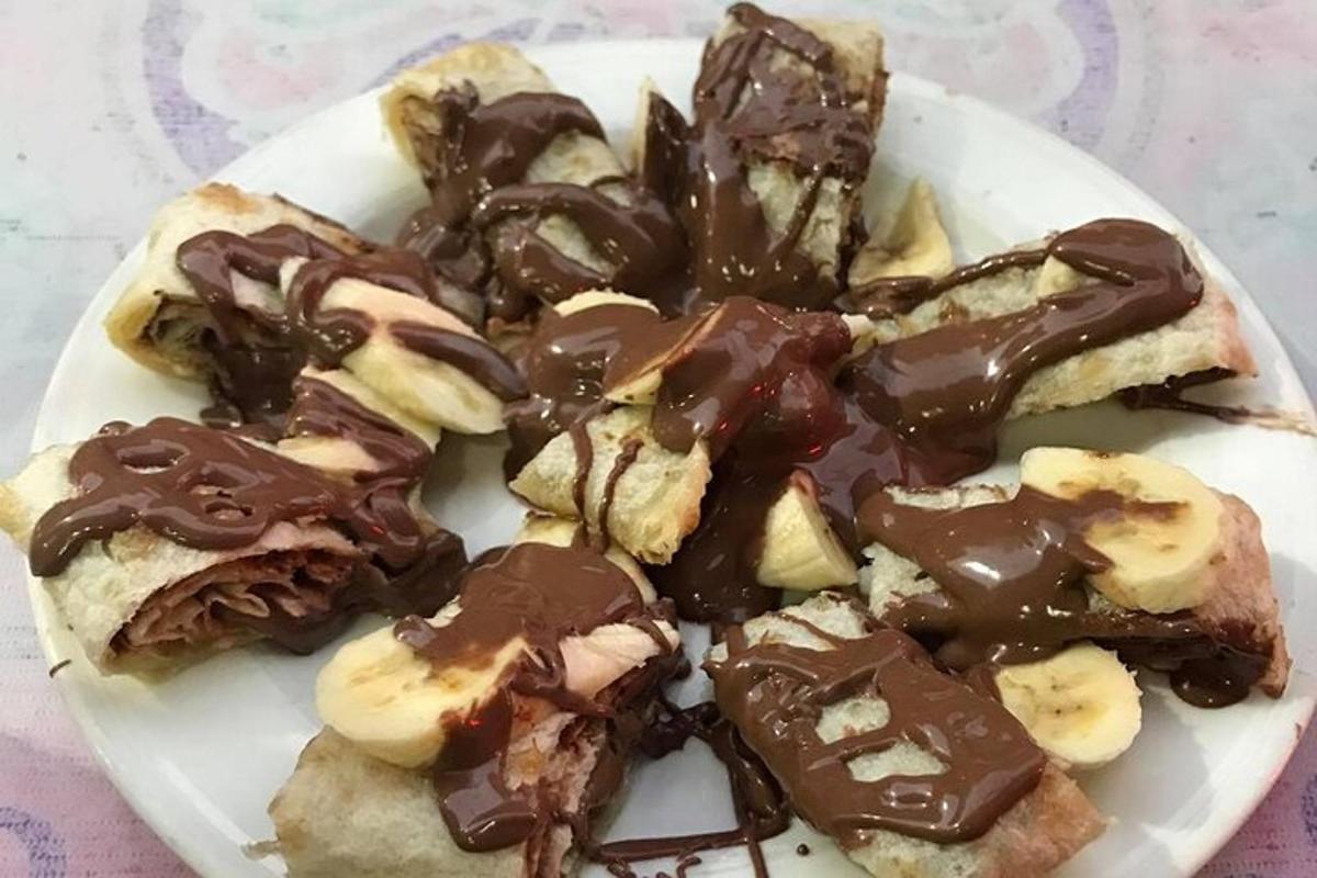a plate of food with chocolate and banana slices