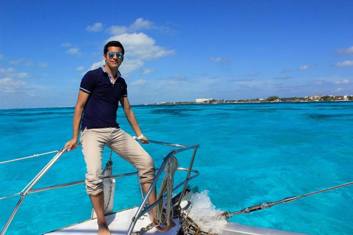 a man standing on the front of a boat in the water