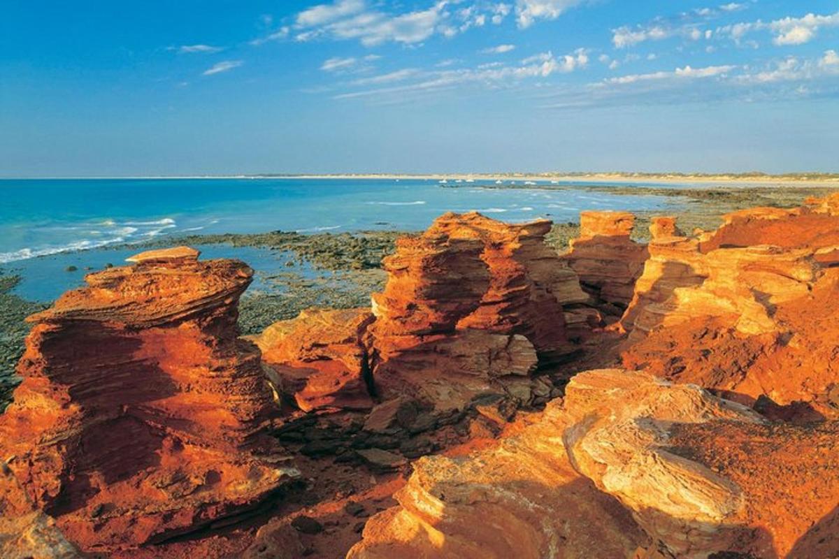 a view of the ocean and some rocks and the water