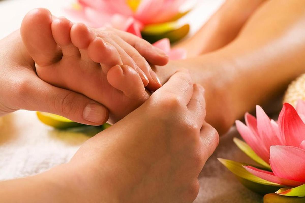 a close up of a persons feet with pink flowers