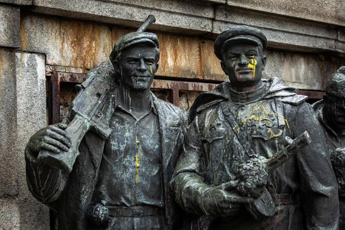 a statue of two men standing in front of a building