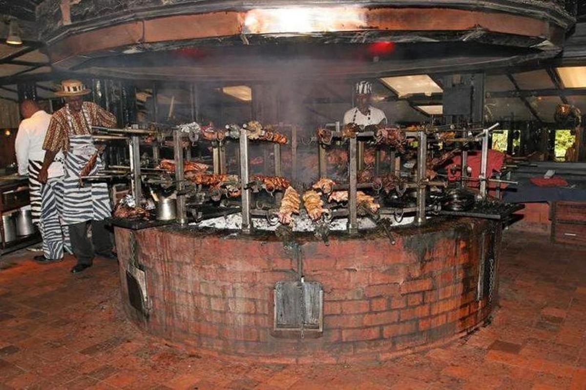 a kitchen with a bar with food on top of it