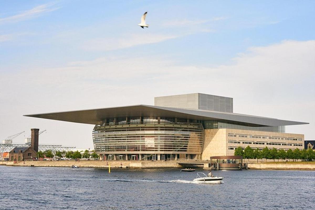 a large building with a bird flying over the water