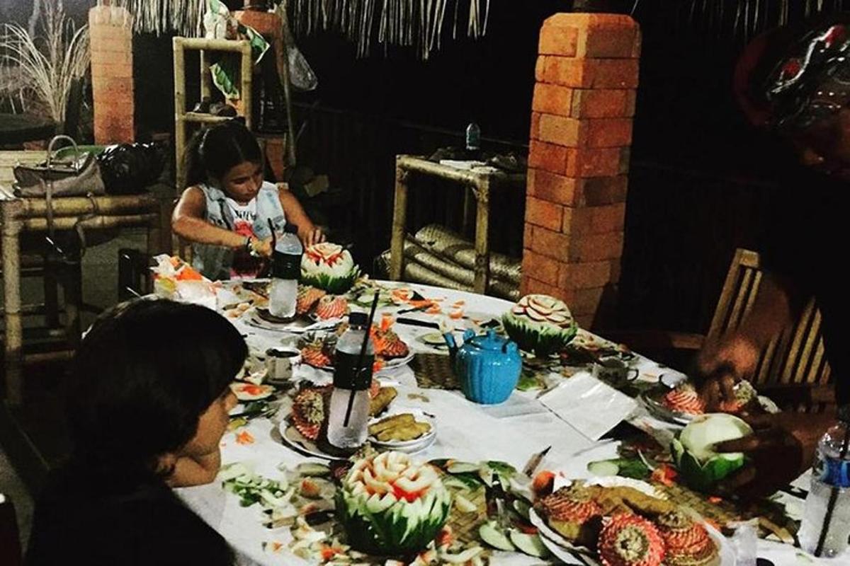 a group of people sitting at a table with food