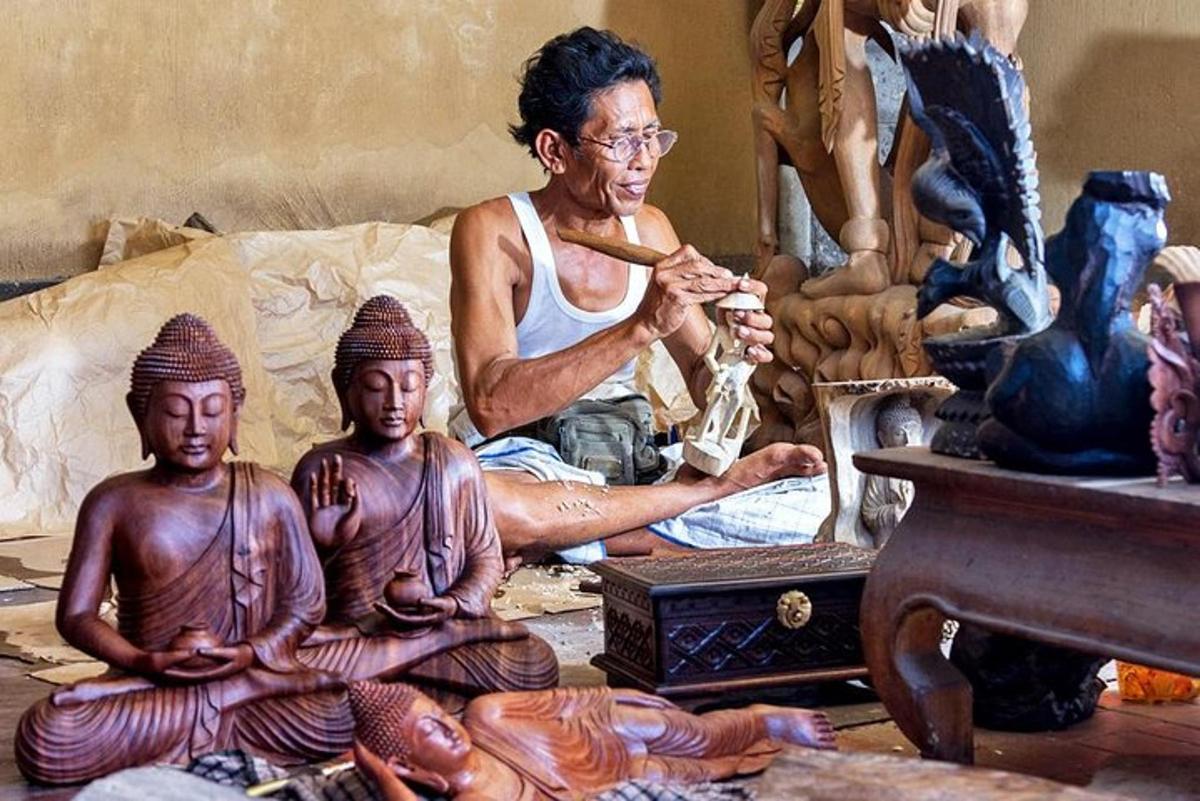 a man sitting in a room with statues oficans
