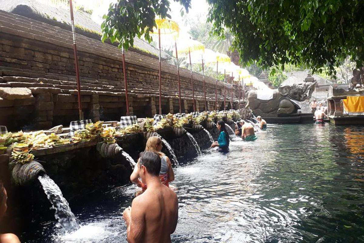 a group of people bathing in a pool of water